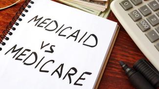 Book with text Medicaid Vs Medicare